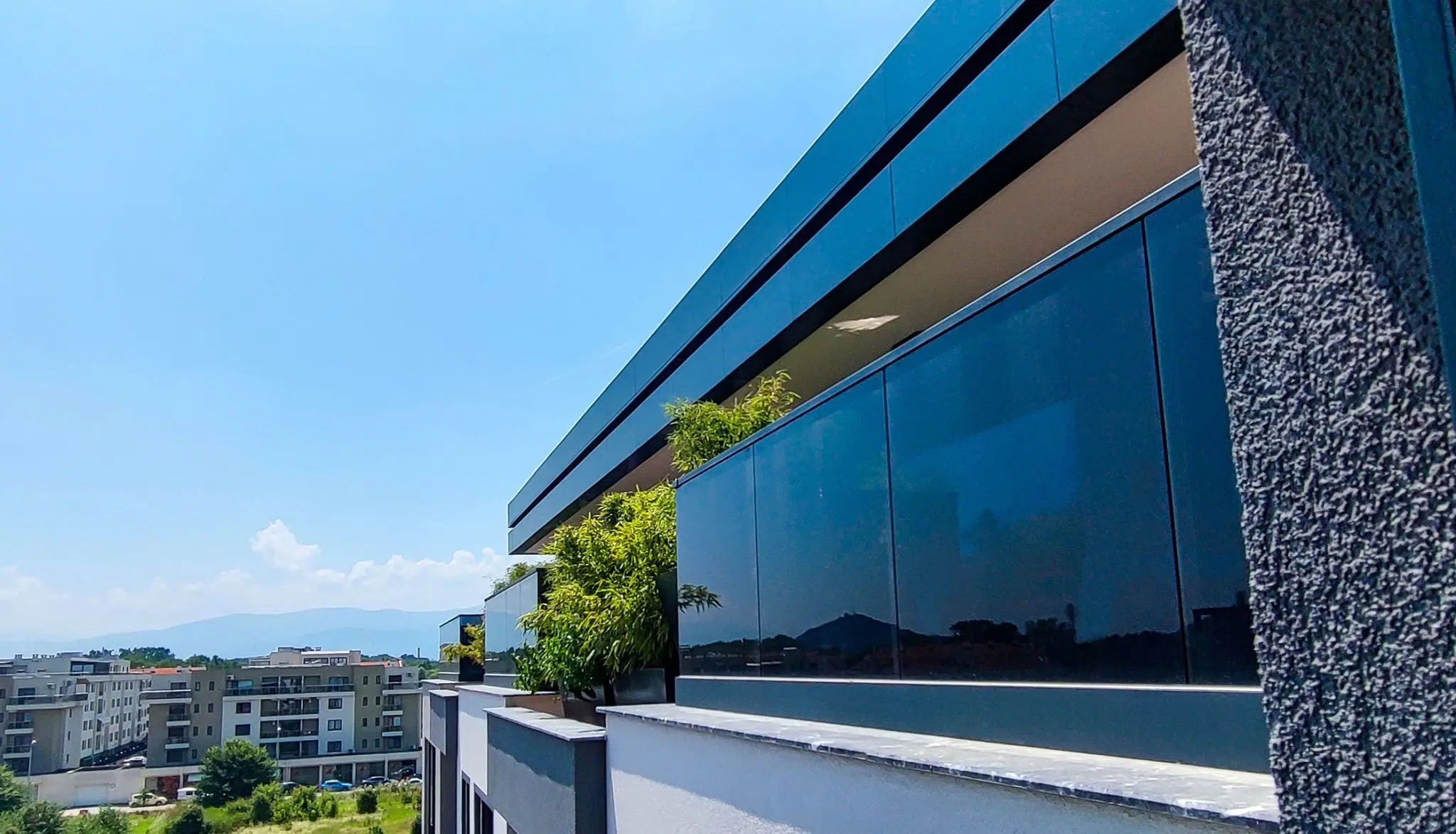 Azalia Park building facade with dark architectural glass railings